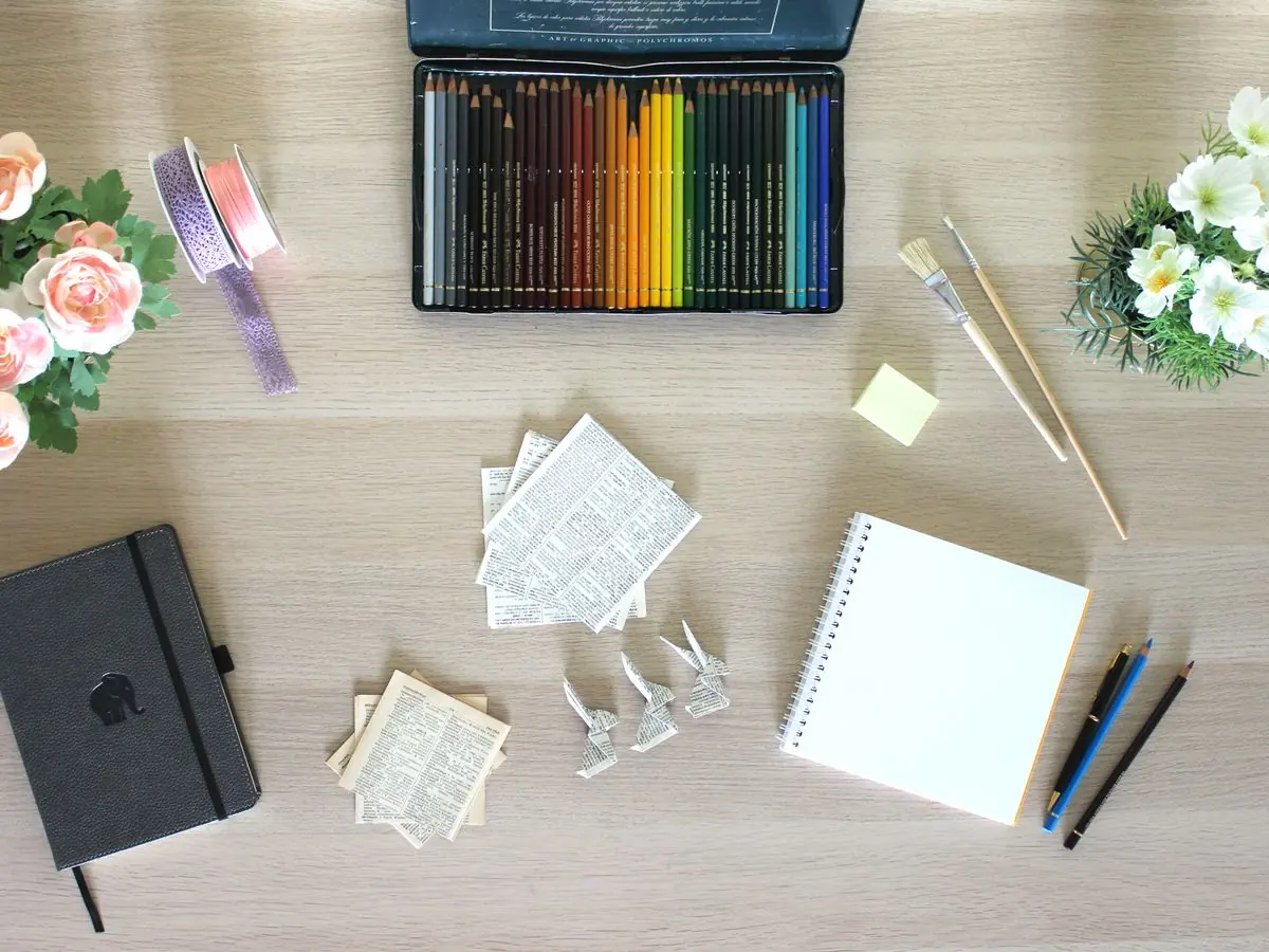 Art supplies laid out on a wooden table